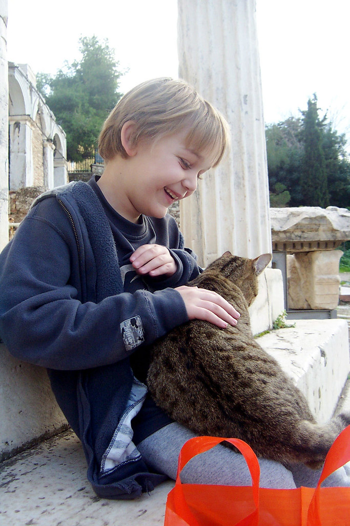 A visitor with a cat at the Roman Agora in Athens