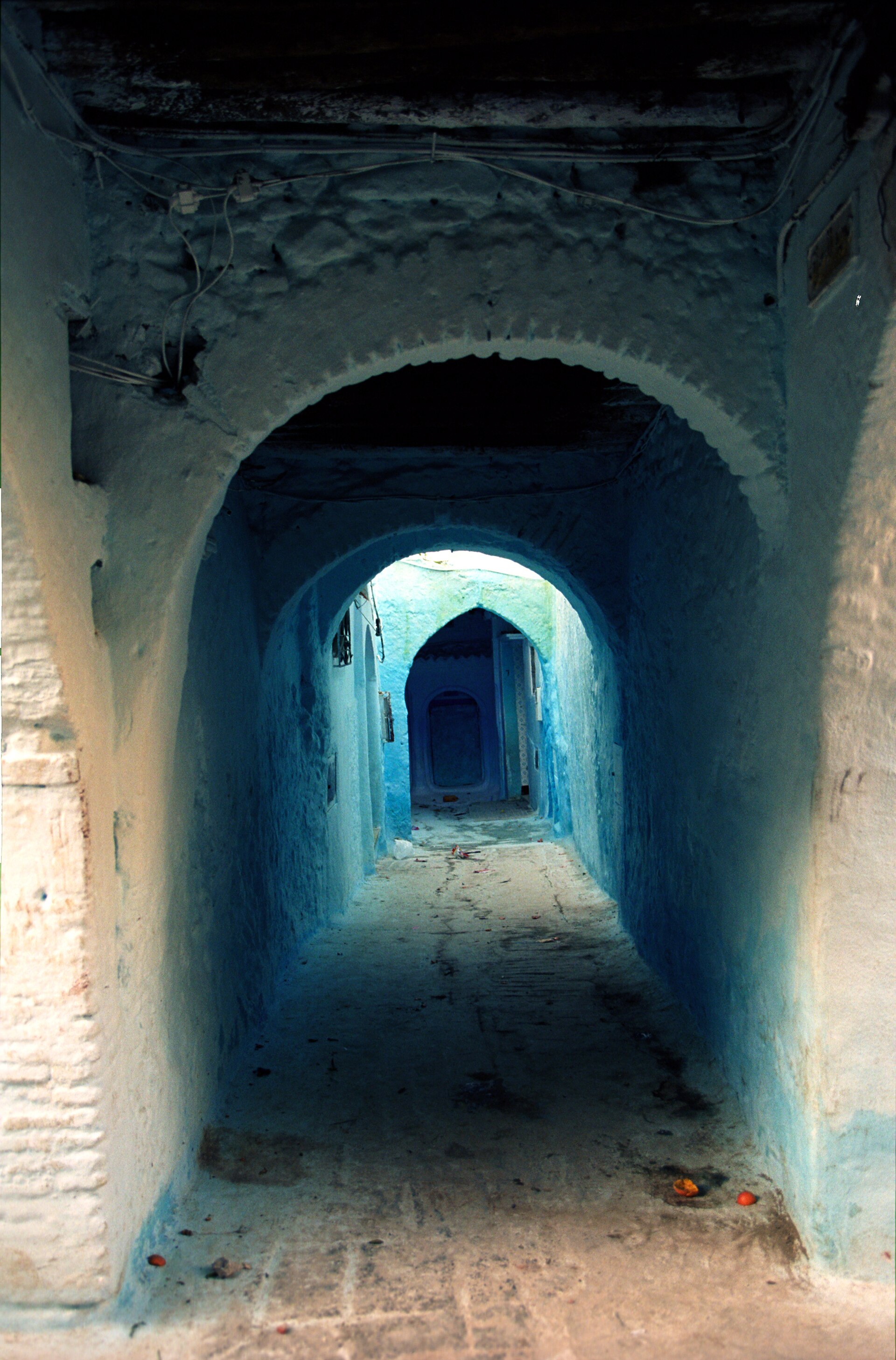 A blue-washed house front in Chefchaouen with a wooden door
