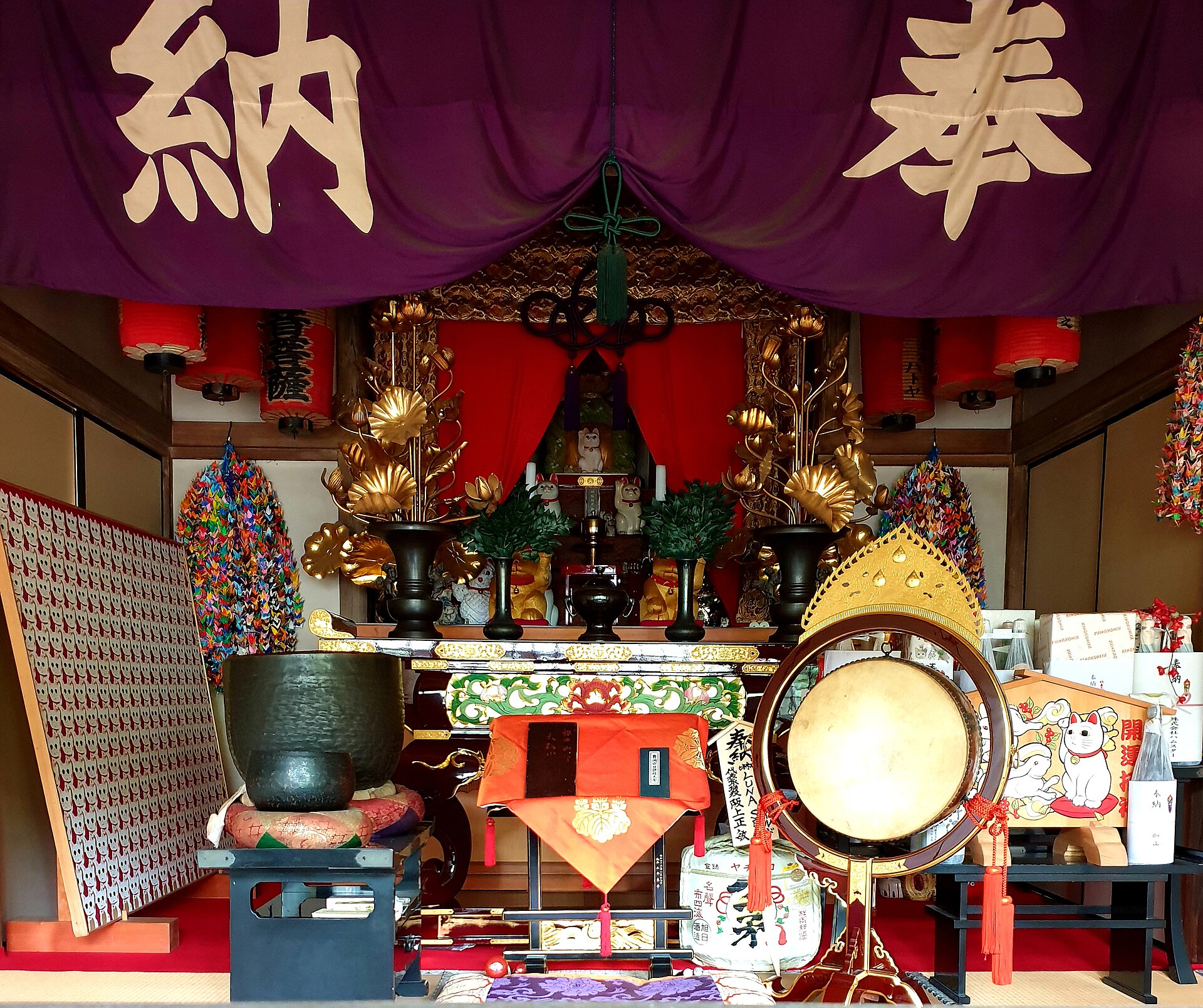 Shelves of white maneki-neko lucky cats at Gotokuji, the cat temple in Tokyo