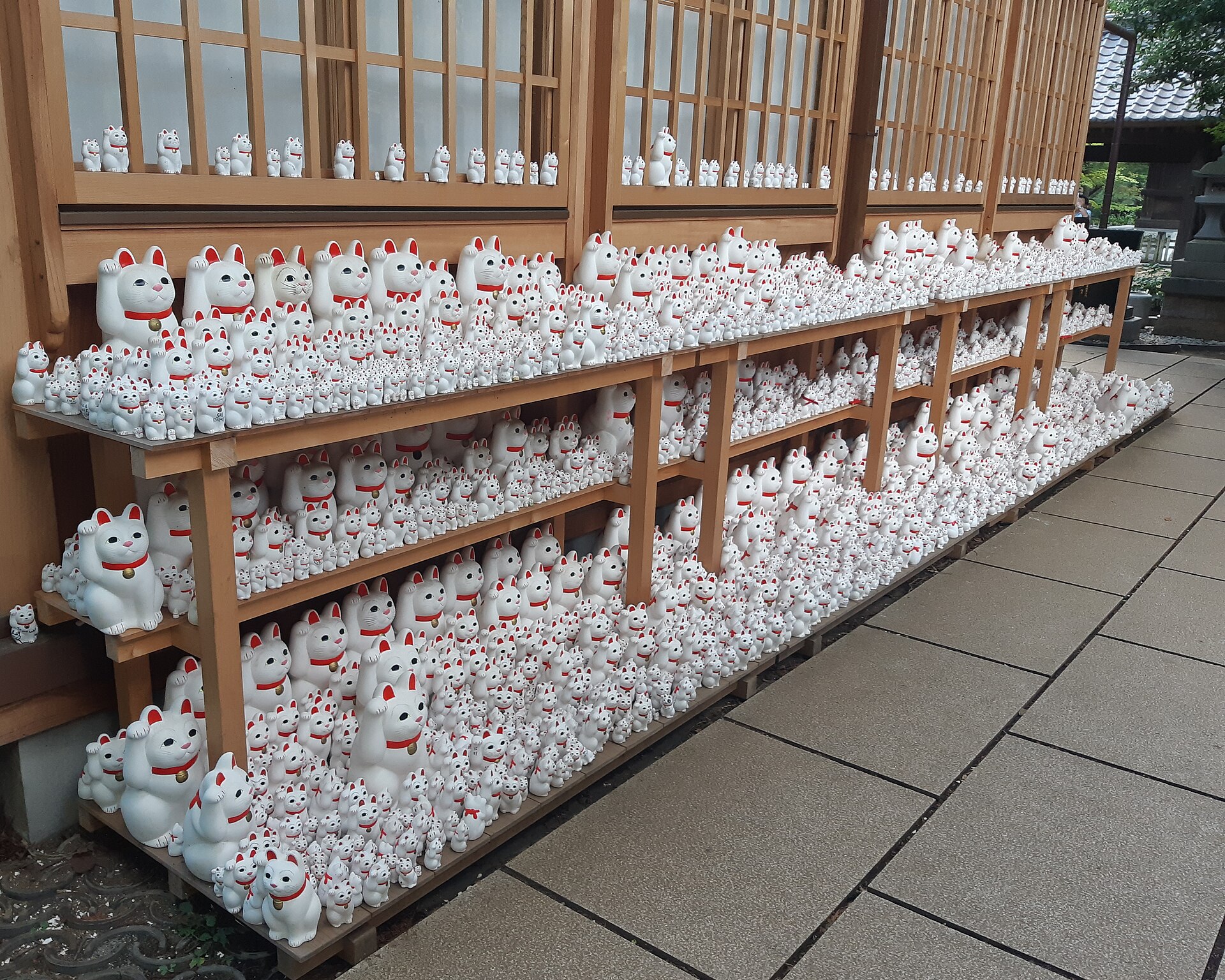 Shelves of beckoning cat figurines at Gotokuji Temple, Tokyo